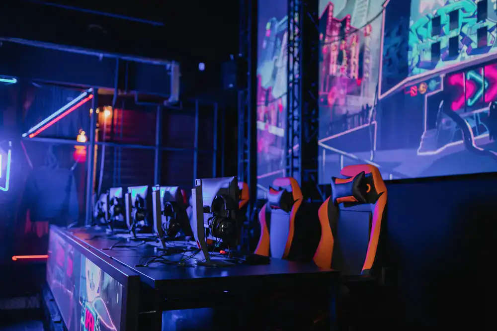 Rows of high-end gaming stations in a dark room with neon accents